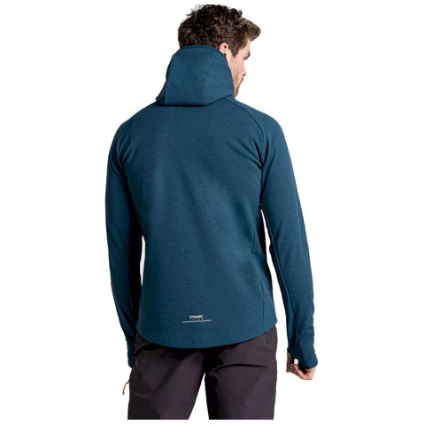 A man wearing a teal hoodie is facing away from the viewer his arm is partially raised as if adjusting the hoodie in a neutral background without distractions.