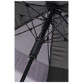 A black umbrella is opened with its structure visible showing the ribs and a mesh texture underneath while the central pole has a rubber grip and spring mechanism for flexibility.