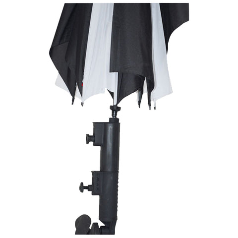 A photography umbrella stands upright with a black and white fabric canopy extended above. It is mounted on a black plastic light stand with adjustment knobs in a studio environment.