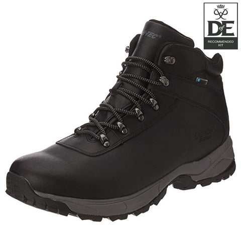 A black hiking boot with metal eyelets and dark laces is positioned at an angle showcasing its sturdy design and rugged sole suitable for outdoor activities against a neutral background.