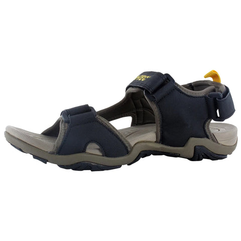 A black and gray sandal rests on a flat surface featuring adjustable straps and a textured sole designed for outdoor activities providing comfort and stability for various terrains.