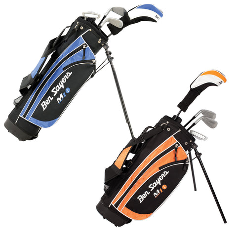 Ben Sayers Junior M1i Package Sets Two golf bags are displayed standing upright with clubs protruding from the tops. One bag is blue and black while the other is orange and black. Both feature the brand name prominently displayed.