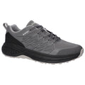 A gray athletic shoe is positioned prominently with a patterned mesh upper and black accents featuring laces and a cushioned sole suggesting its purpose for outdoor activities or running.