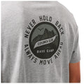 A grey t-shirt features a circular graphic with mountains and a bird. The text reads NEVER HOLD BACK EXPLORER CLUB BASE CAMP ALWAYS MOVE AHEAD CRAIGHOPPERS.