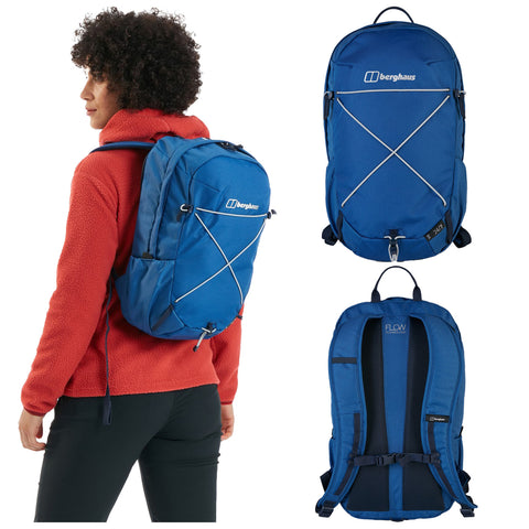 A blue backpack is worn by a person with curly hair. The backpack features a logo on the front and elastic bungee straps. The person is dressed in a red fleece.