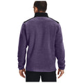 A person is facing away, wearing a purple fleece jacket with a black collar and shoulder detail, in an undefined space that emphasizes the garment's color and texture.