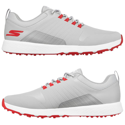 A pair of stylish gray golf shoes features red laces and accents with a prominent treaded sole designed for traction suitable for outdoor activities set against a plain background.