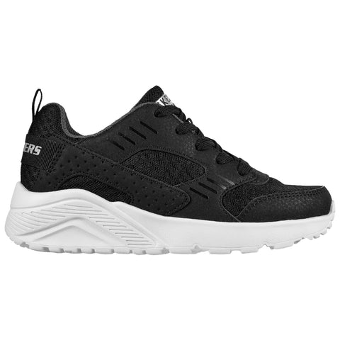 A black athletic shoe with a textured upper and a white sole is displayed facing right against a plain background showcasing its design and athletic style.