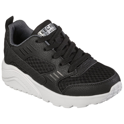 A black sneaker with mesh and synthetic material features laces and a white sole showcasing a sporty design meant for casual wear in a stylized presentation.