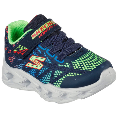 A colorful sneaker designed for children features a navy mesh upper with neon green accents and a white sole displaying a wave pattern and a Velcro strap for fastening.