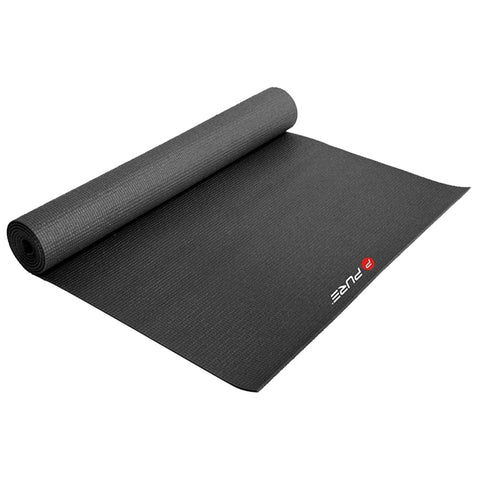 A black yoga mat is rolled partially open on a flat surface ready for use in exercise or meditation environments promoting fitness and mindfulness practices.