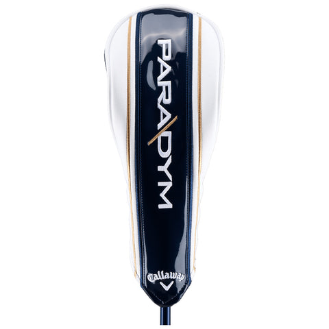 A golf club head cover is positioned upright displaying a sleek design in navy and white with gold accents. The words PARADYM and Callaway are prominently featured on its surface.