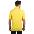 A man is wearing a bright yellow polo shirt while facing away from the viewer with his right hand at his side and his left hand slightly raised the shirt has text that says LIVE LUCKY on the back collar.