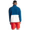 A person stands with their back turned wearing a blue and white fleece jacket and orange shorts against a plain white background, appearing casual and relaxed.