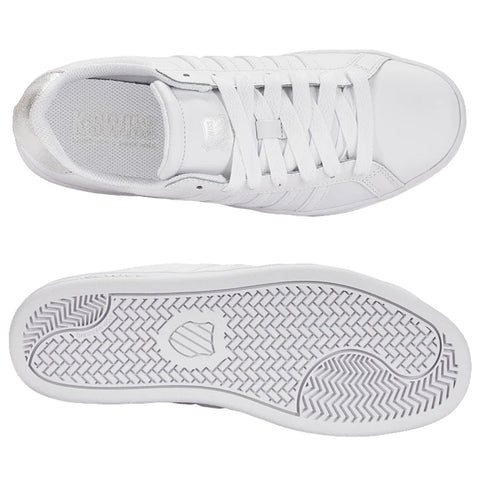 A pair of white sneakers is displayed with the top view showing the laces and a silver accent at the heel while the bottom view reveals a textured sole pattern for traction.