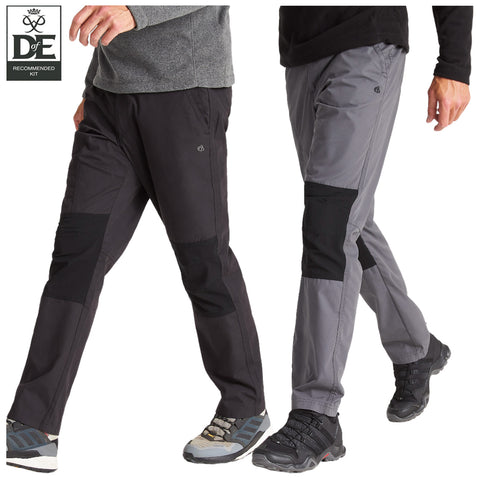 Two pairs of outdoor pants are displayed side by side. The left pair is navy blue, and the right pair is black with an orange zipper detail. Both are worn by models standing.