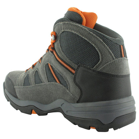 A gray and black hiking boot with orange accents is shown from a side angle positioned on a flat surface designed for outdoor activities featuring a textured sole for traction and stability